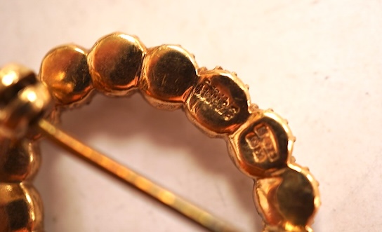 A cabochon amethyst and half pearl brooch, mounted in 9ct gold, length 3.7cm, British hallmarks, gross weight approximately 9.5 grams; and a 9ct half pearl wreath brooch, length 2.1cm, British hallmarks, gross weight 2 g